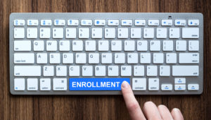 Keyboard showing the word enrollment